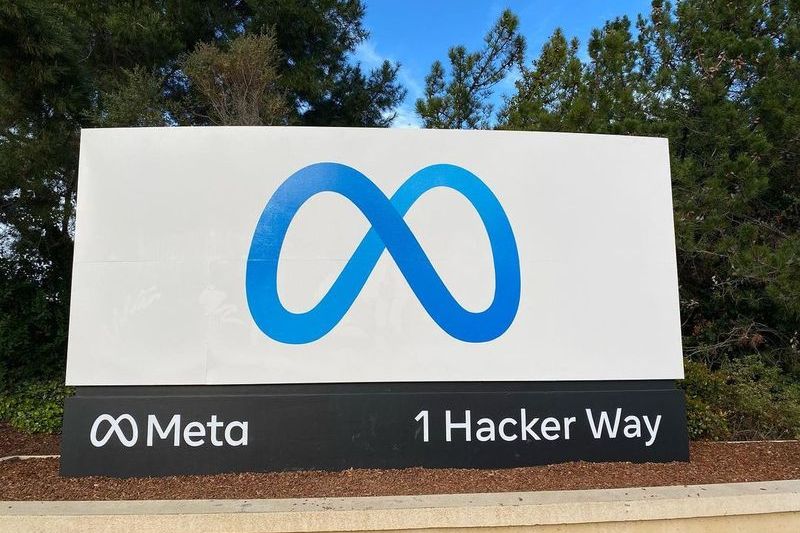 Meta headquarters sign displaying the Meta infinity logo and address 1 Hacker Way in Menlo Park, California