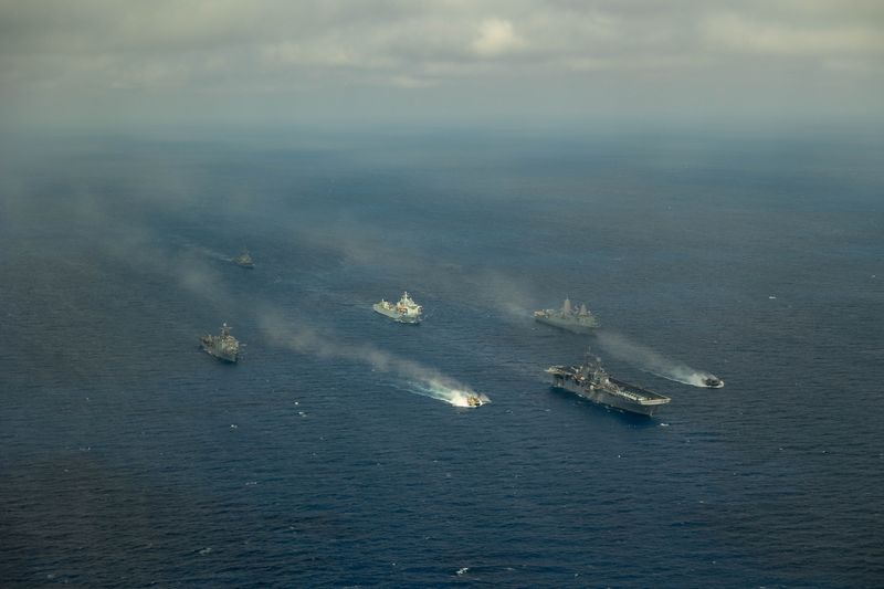 Aerial view of the Bataan Amphibious Ready Group — including USS Bataan and accompanying amphibious warships — transiting in formation at sea