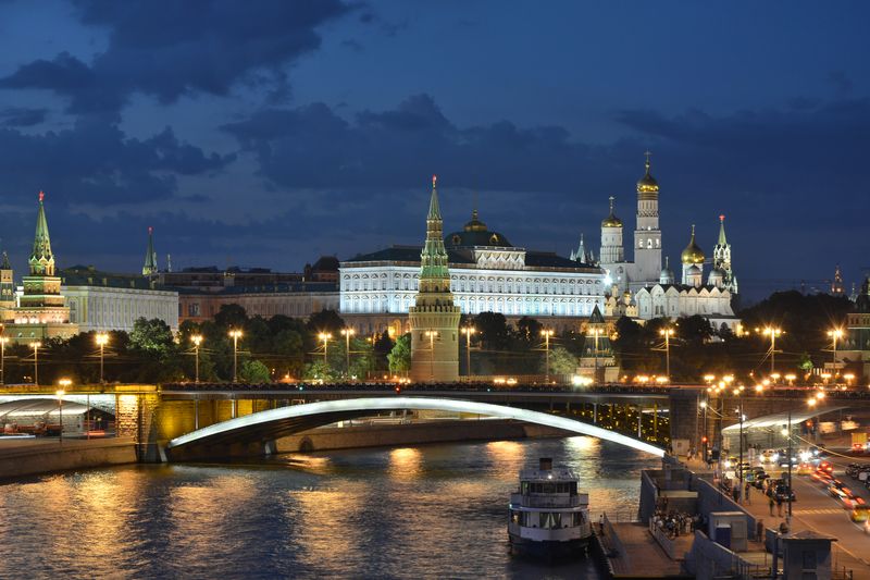 The Moscow Kremlin illuminated at night, viewed across the Moskva River with Bolshoy Kamenny Bridge in the foreground