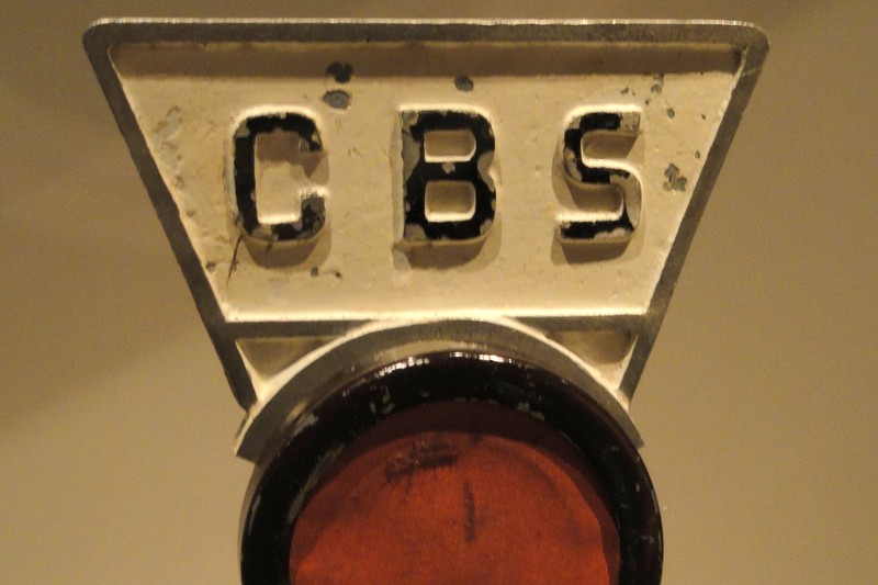 Vintage 1930s CBS-branded radio microphone on a brass stand, from the National Museum of American History