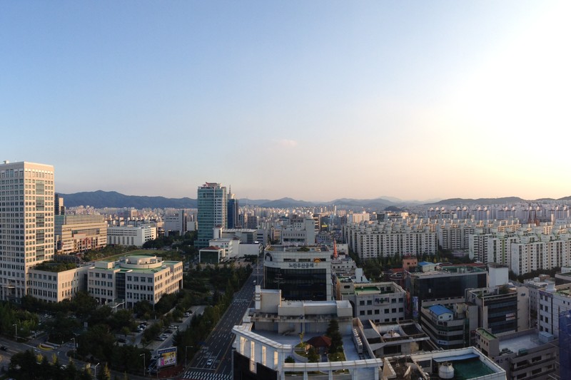 Panoramic view of Daejeon, South Korea, showing the city skyline with buildings and mountains in the background