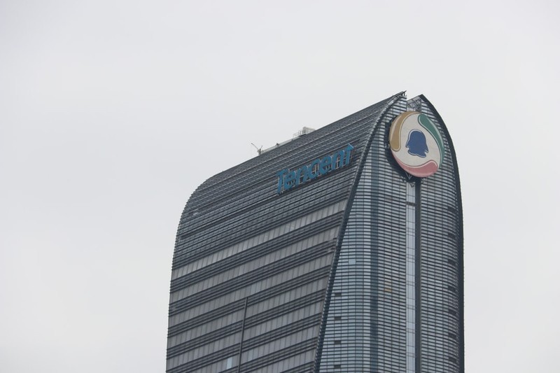 Tencent headquarters skyscraper with the company logo and QQ penguin emblem on the building's facade