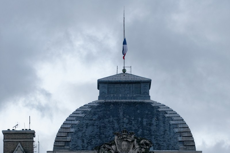 French flag flying at half-mast at the Palais de Justice in Paris