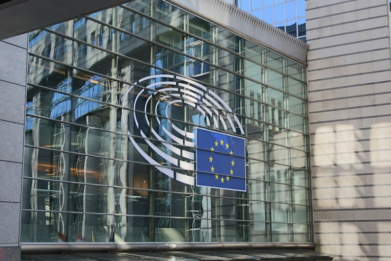 European Parliament building facade with EU flag and emblem
