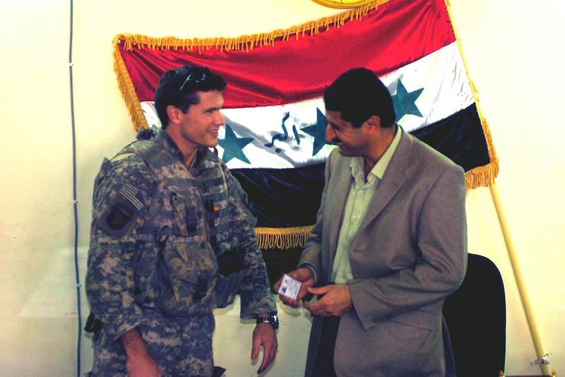 Pete Hegseth in military uniform meeting with Iraqi official in 2005