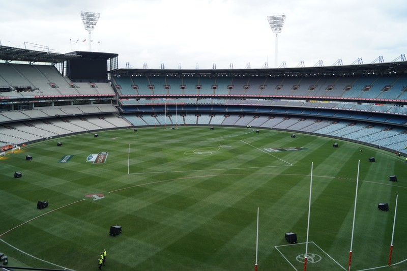 Aerial view of the Melbourne Cricket Ground stadium with its green field and tiered seating