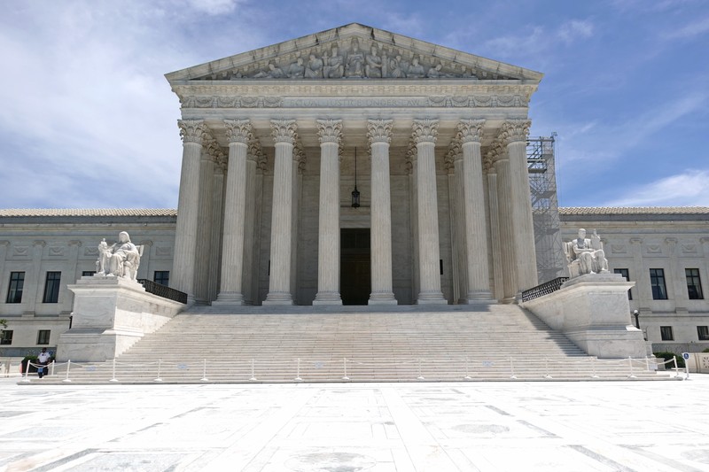The United States Supreme Court building in Washington, D.C., featuring its iconic neoclassical architecture with marble columns and pediment