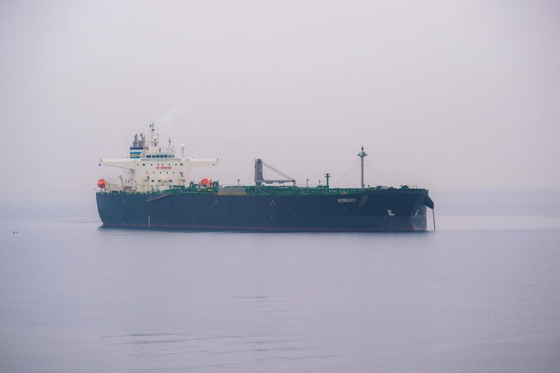 A large cargo ship navigating through foggy waters