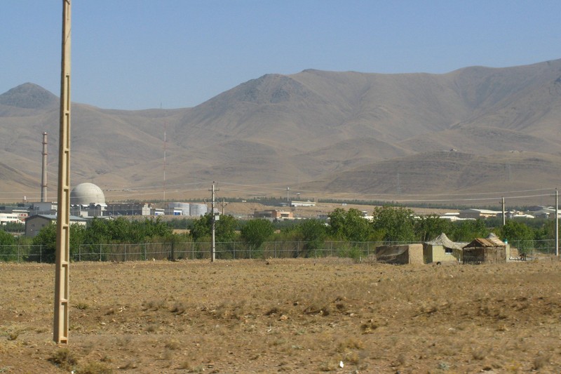 Aerial view of the Arak IR-40 Heavy Water Reactor facility in Iran, with industrial buildings, a white dome structure, and mountains in the background.