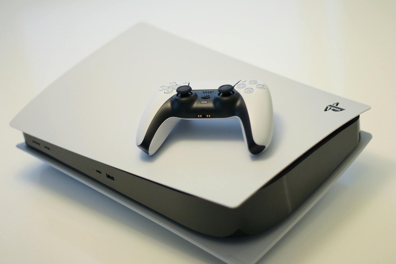 PlayStation 5 console with DualSense controller on light background