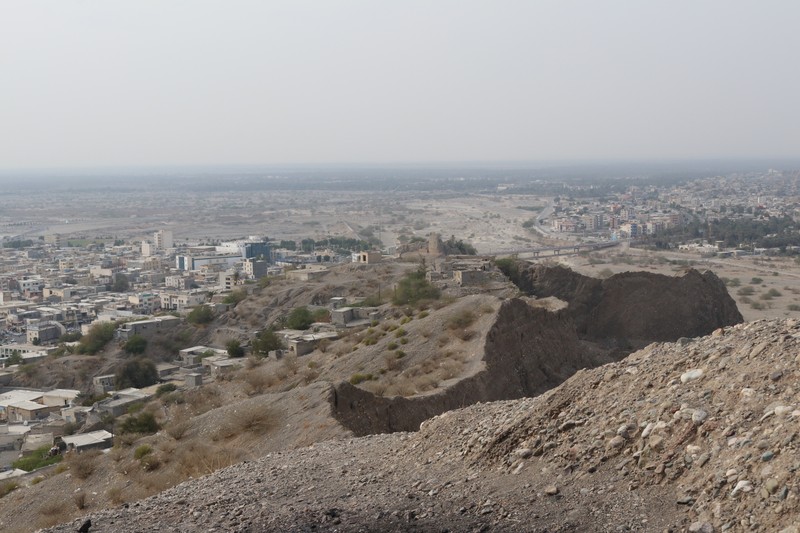 Ruins of Minab Castle in Hormozgan province, southern Iran, with palm trees and arid landscape