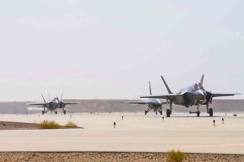 U.S. Air Force F-35 Lightning II and F-16 Fighting Falcon aircraft taxi on the flight line at Prince Sultan Air Base, Saudi Arabia