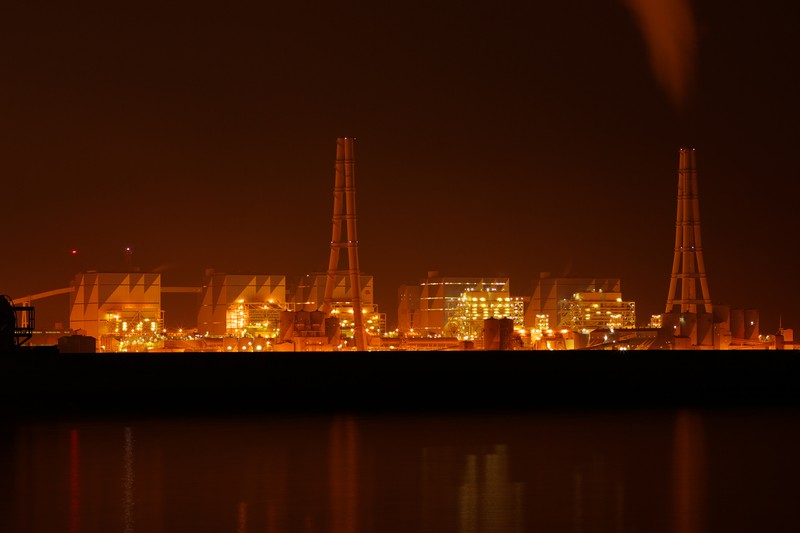 Hekinan Thermal Power Station illuminated at night, reflecting in calm water