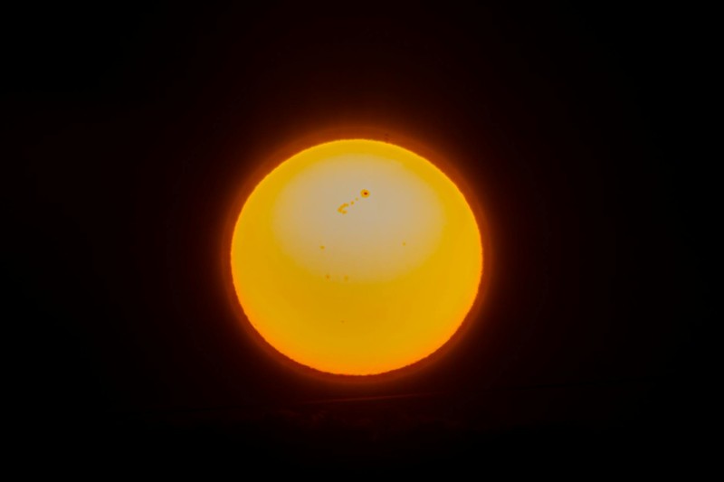 Close-up view of the Sun showing sunspots and surface detail against a black background
