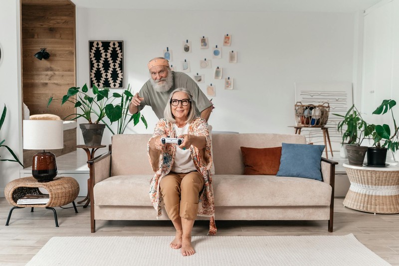 A couple enjoying a video game together on a cozy living room sofa