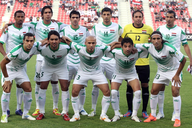 Iraq national football team posing in a team photo on a stadium pitch before a FIFA World Cup qualifying match