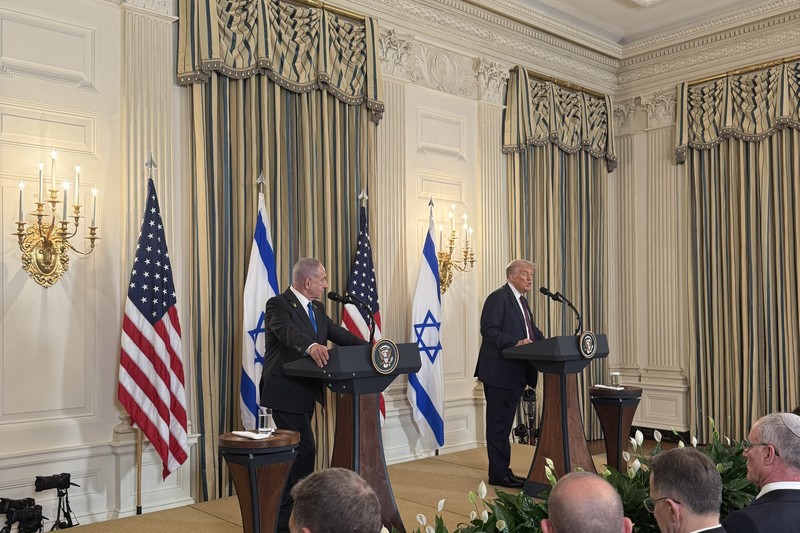 President Trump at a joint press conference with the Israeli Prime Minister, with U.S. and Israeli flags visible