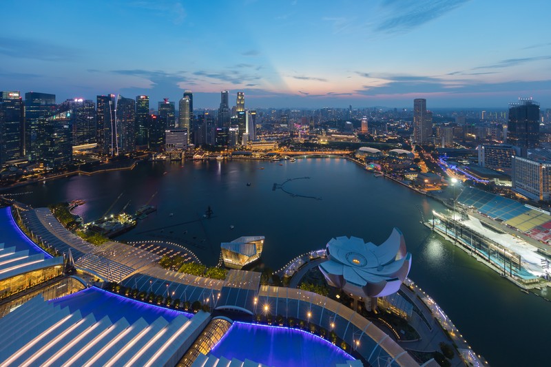 Singapore's Marina Bay skyline at dusk, featuring Marina Bay Sands and the ArtScience Museum