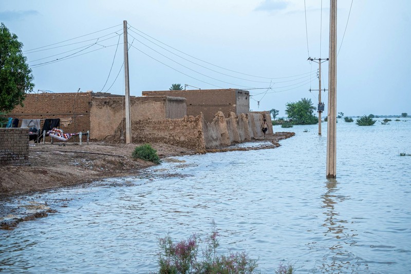 Flooded rural area with submerged buildings and utility poles in Balochistan, Pakistan