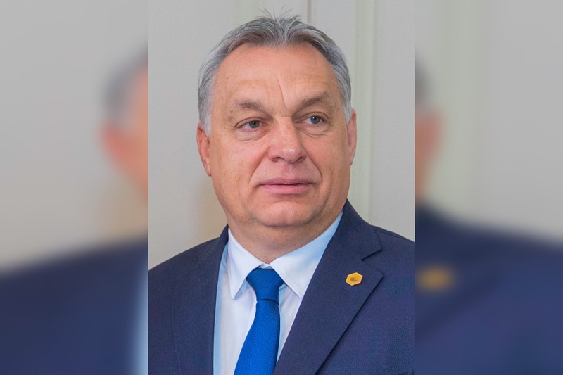 Portrait of Hungarian Prime Minister Viktor Orbán looking to the side against a plain background