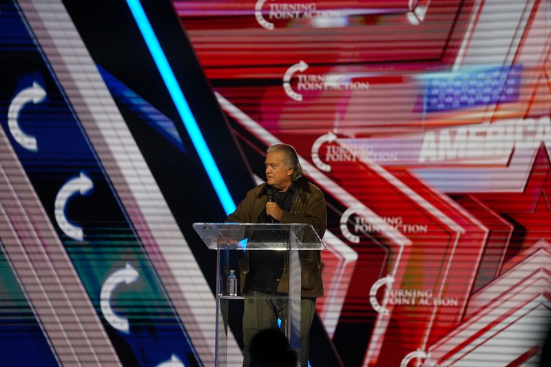 Steve Bannon speaking at a podium at a political event