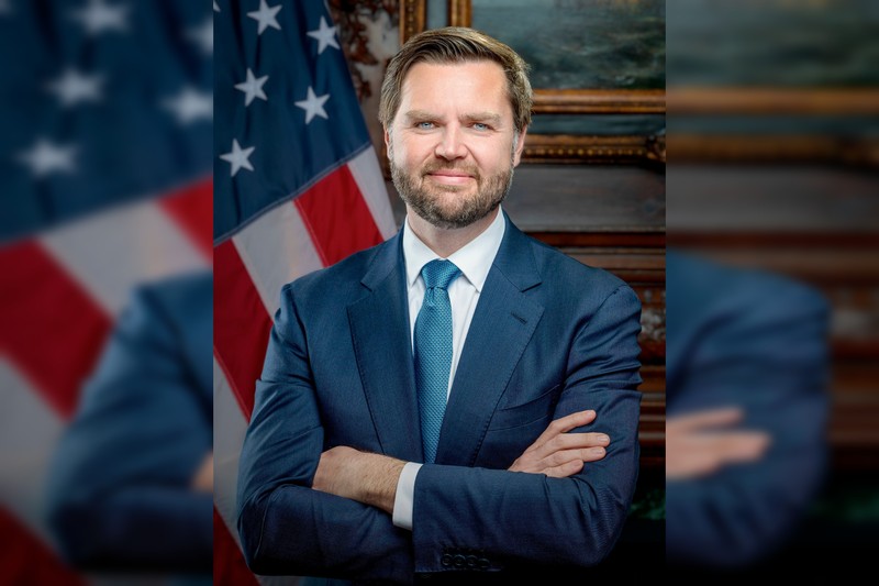 JD Vance in an official portrait with an American flag in the background