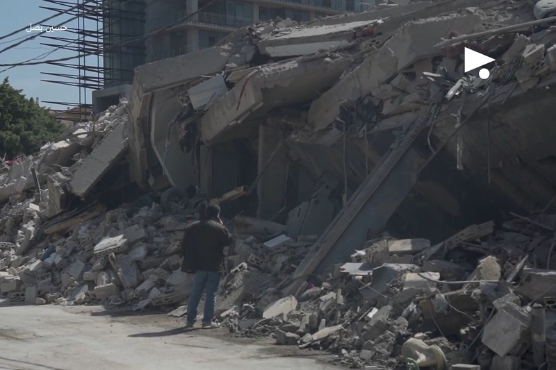 A man surveys the wreckage of a collapsed building in Beirut's Bachoura neighbourhood following Israeli airstrikes