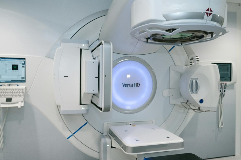 A Versa HD linear accelerator machine in a radiation therapy room at a cancer treatment center