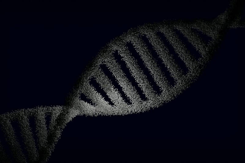 Artistic rendering of a DNA double helix with particle effects against a dark background