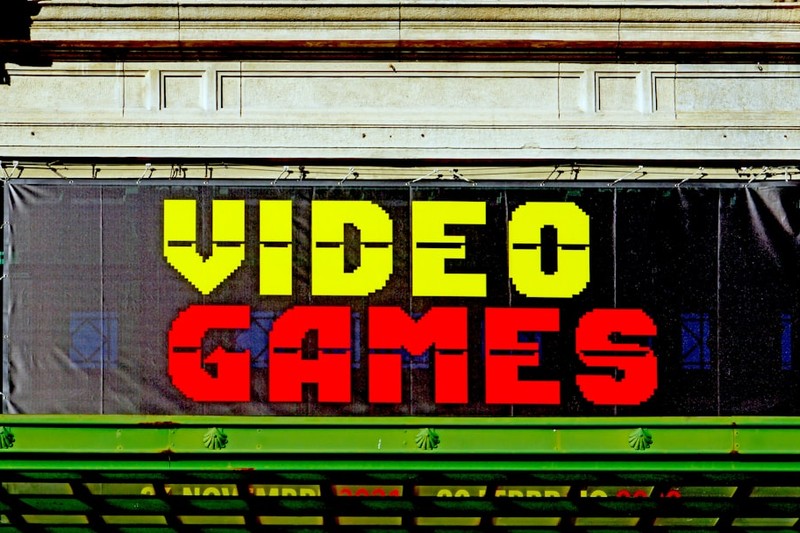 Retro pixelated 'VIDEO GAMES' sign on a storefront