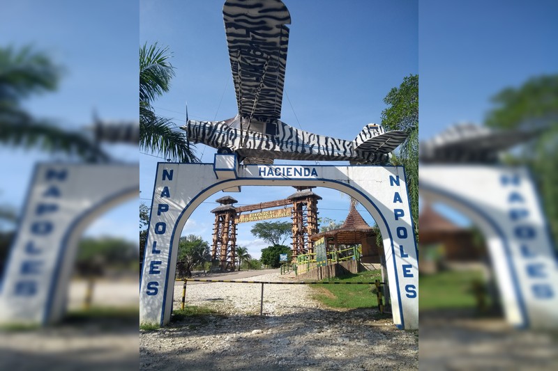 The main entrance to Hacienda Nápoles theme park featuring a zebra-striped airplane mounted above the gateway