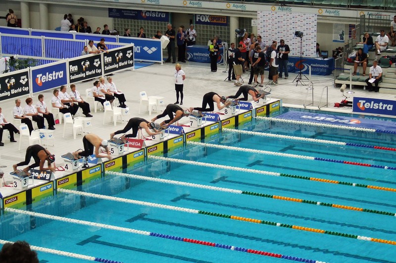 Swimmers on starting blocks at the 2008 FINA World Cup swimming competition at the Sydney Olympic Park Aquatic Centre