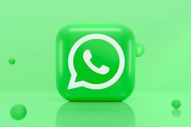 A 3D-rendered WhatsApp icon on a green background with floating chat bubbles