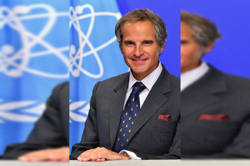 IAEA Director General Rafael Mariano Grossi poses for an official portrait in front of the IAEA atomic symbol