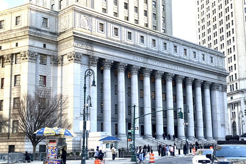 Neoclassical US federal courthouse with tall columns and grand stone steps