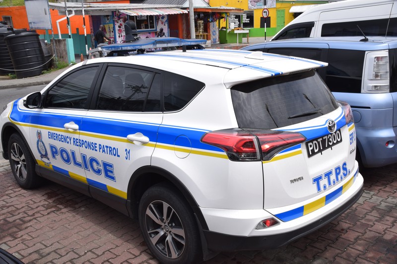 A Trinidad and Tobago police SUV parked in an urban area on Tobago