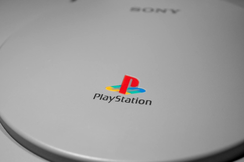 Two young women happily playing a video game indoors, showcasing leisure and connection.