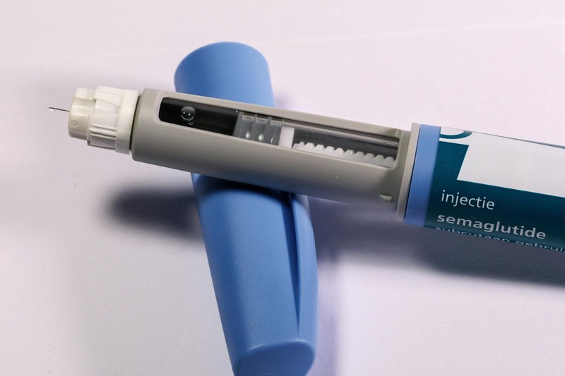 A semaglutide injection pen on a plain background