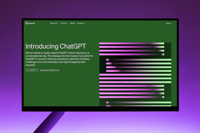 A computer monitor displaying the OpenAI ChatGPT introduction webpage with a green background