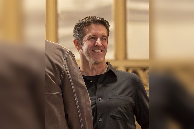 John Ternus smiling at Apple's 50th-anniversary kickoff event at Apple's Grand Central Terminal store in New York City.