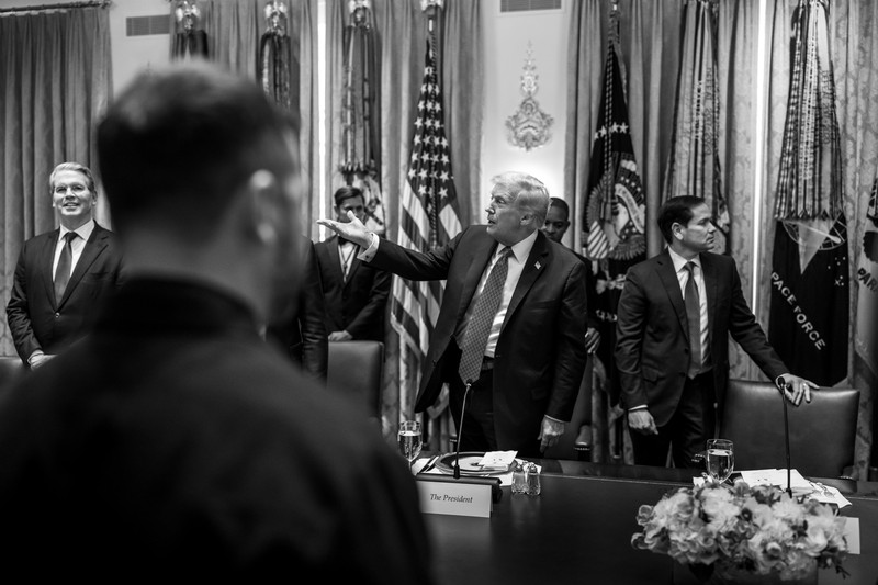 President Donald Trump speaking in the Cabinet Room of the White House, with officials and American flags visible