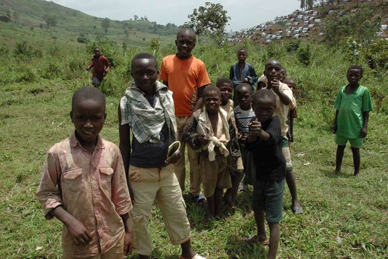 Displaced people, including children, gather in a rural area near Nyanzale in the Democratic Republic of Congo
