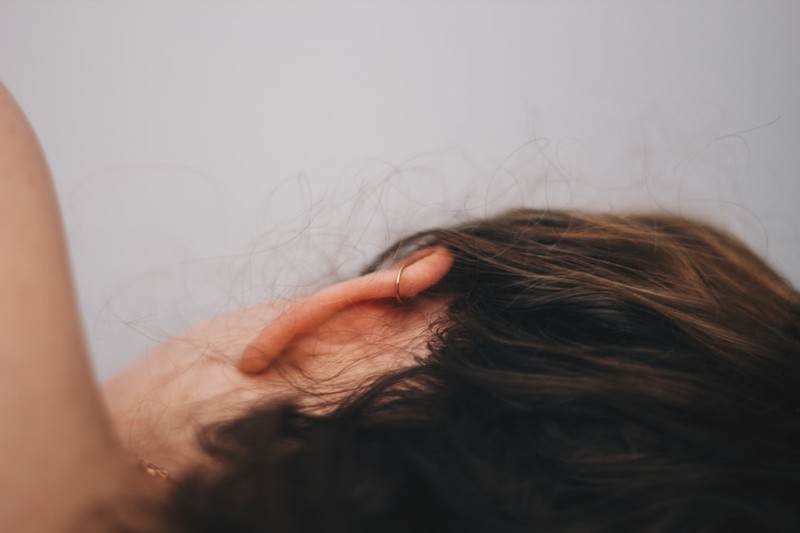 Close-up of a person's ear with soft lighting