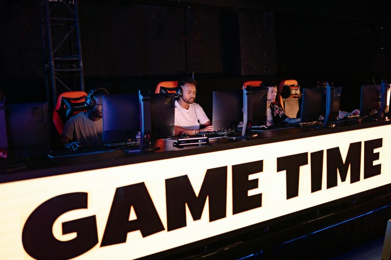Gamers competing at monitors during a gaming tournament event