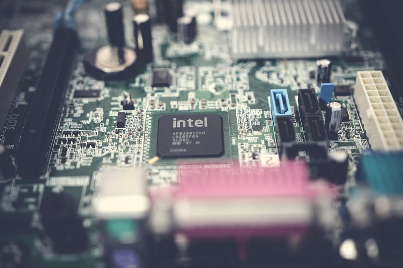 Close-up of an Intel microprocessor on a computer motherboard with surrounding electronic components