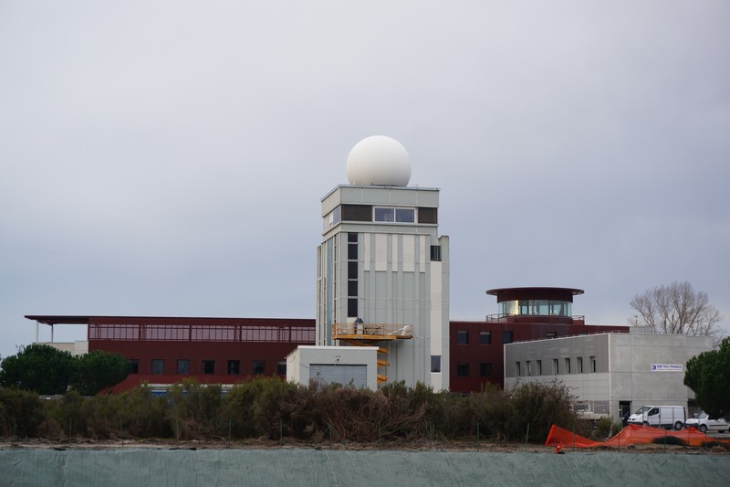 A weather station at Mérignac, France, featuring a large radar dome and surrounding facility buildings under an overcast sky