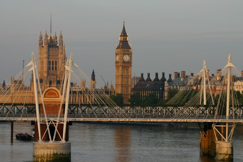 The Houses of Parliament and Elizabeth Tower (Big Ben) seen from across the River Thames in Westminster, London.