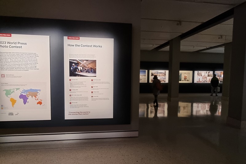 World Press Photo exhibition display panels in a gallery space showing contest information and world map