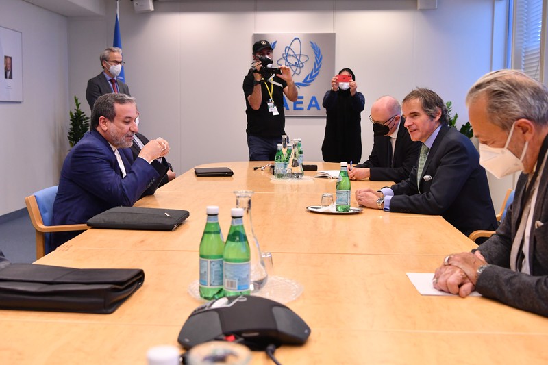 IAEA Director General Rafael Mariano Grossi meets with Iranian Deputy Foreign Minister Seyed Abbas Araghchi at a formal conference table in Vienna