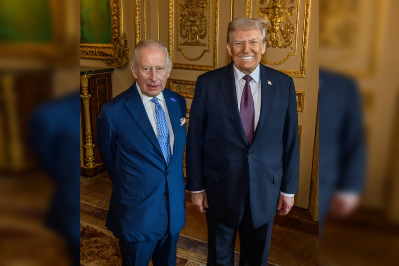 King Charles III and Donald Trump posing together in an ornate room during a formal meeting